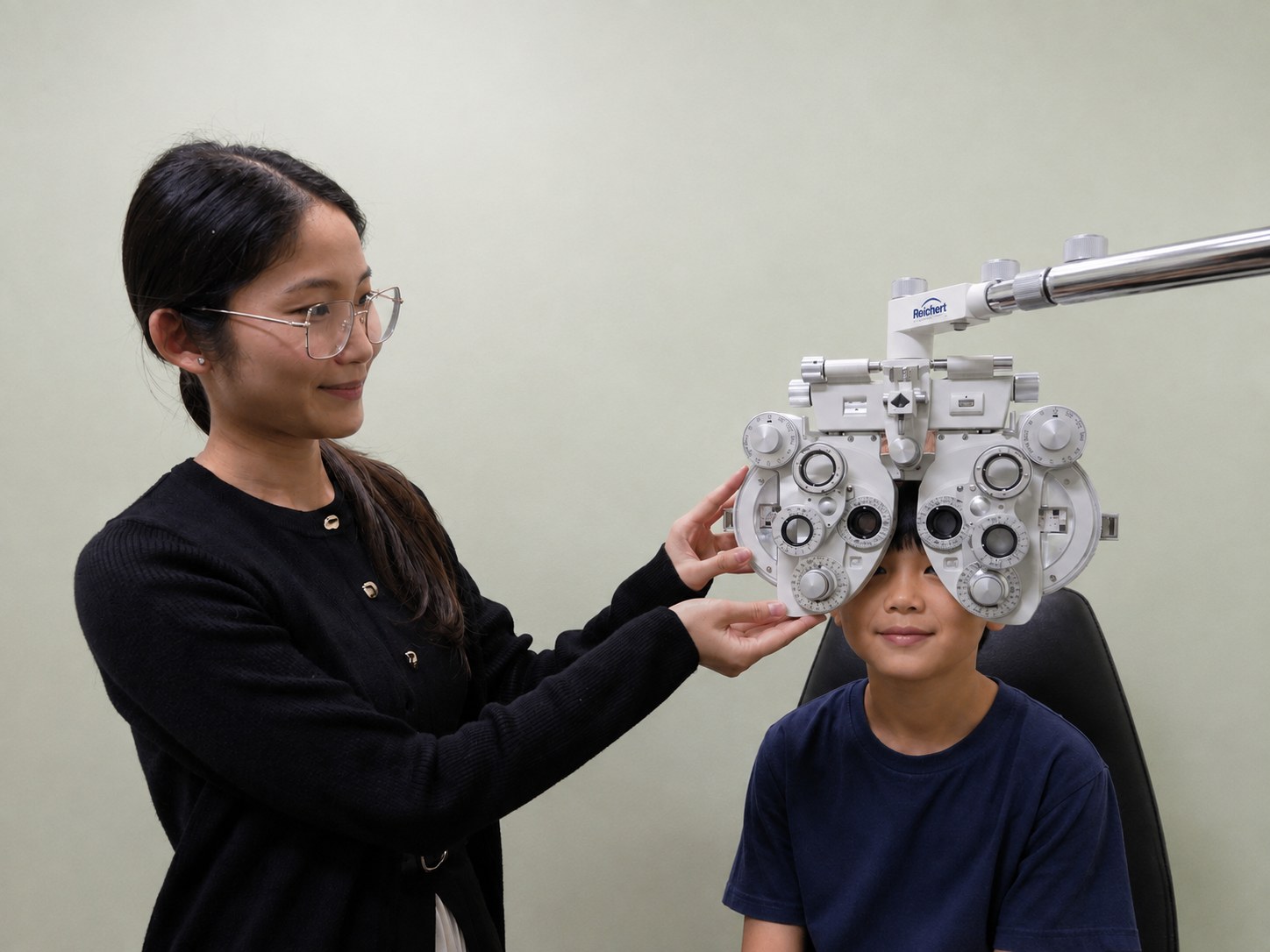 Optometrist Wendy Nguyen positioning the phoropter for a child during an eye examination