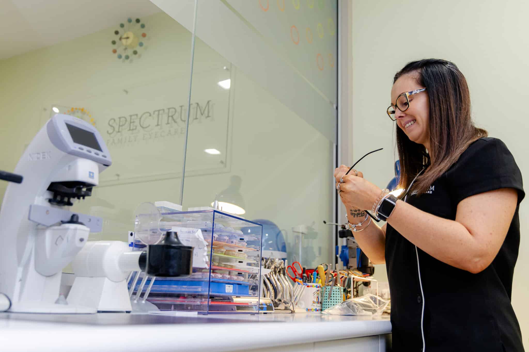 A Spectrum team member inspecting a pair of glasses at the workshop