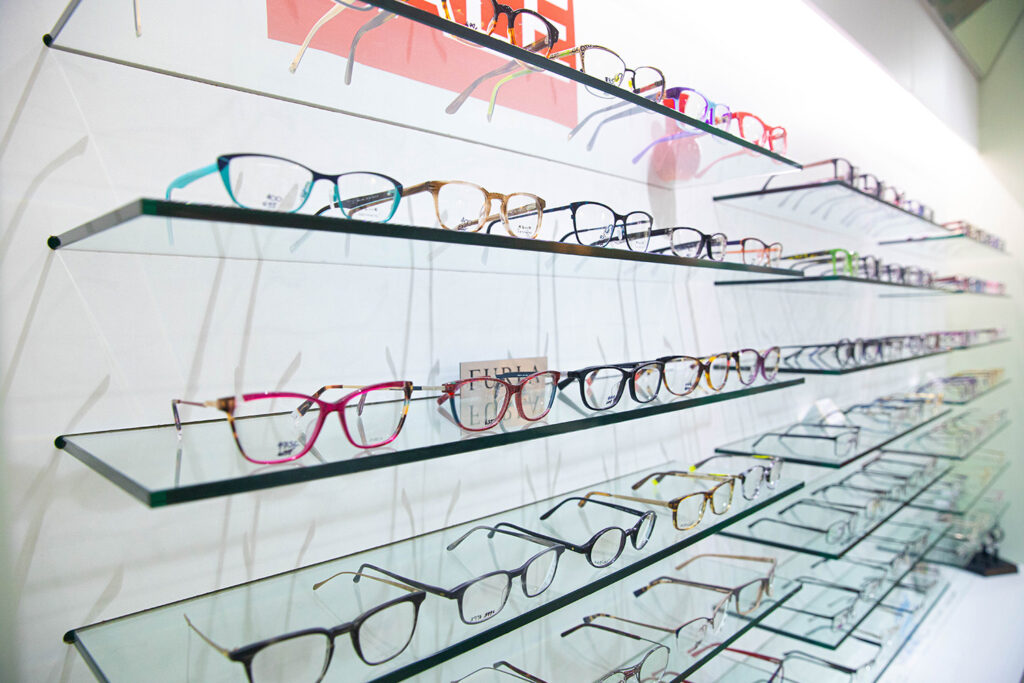 Large range of colourful glasses being displayed on a wall in the Spectrum shop