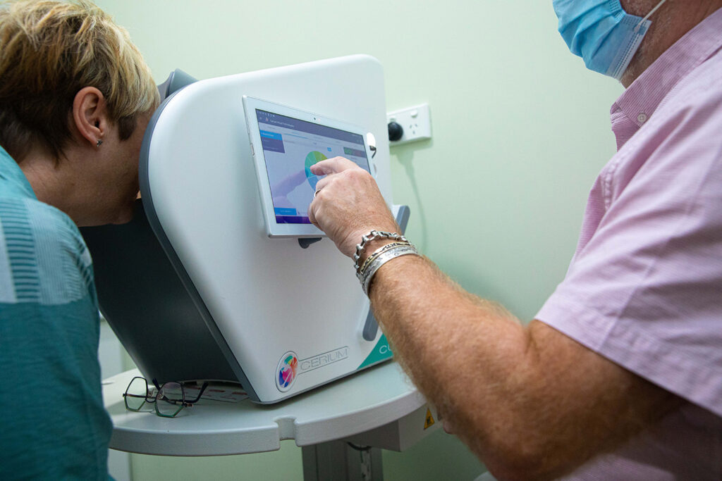 Spectrum employee performing an eye examination on a comfortable patient