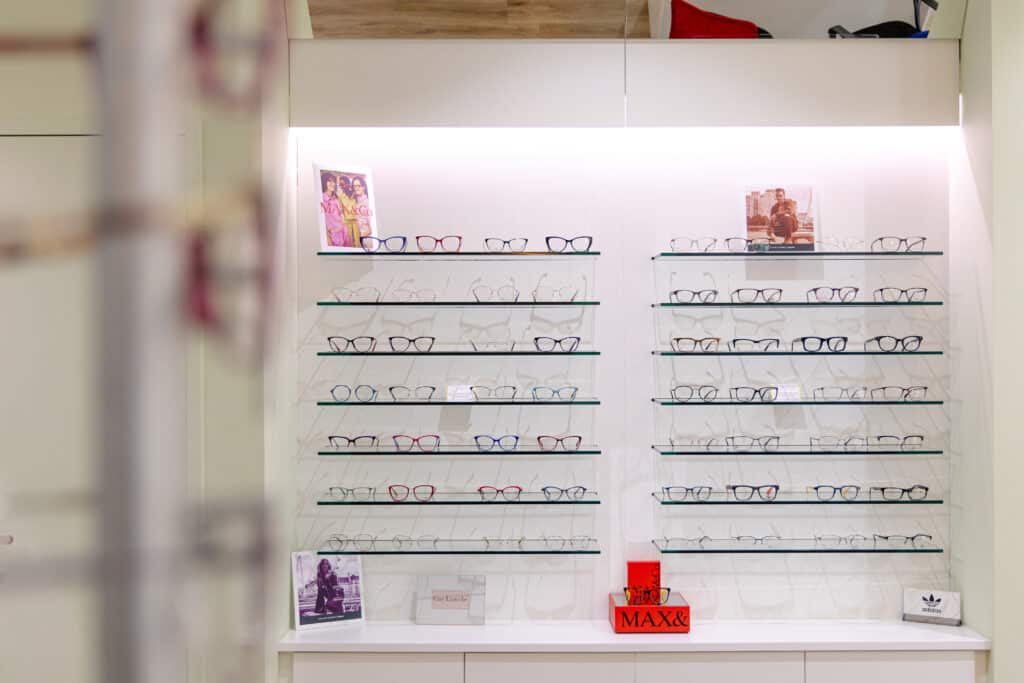 Eye glasses lined up on a shelf in a store